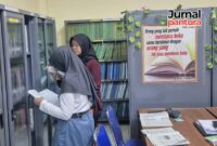 Fatimah bersama temannya tampak antusias memilih buku bacaan di Perpustakaan Daerah Kudus yang kini buka hingga malam hari. Layanan ini memberi kesempatan bagi pelajar untuk tetap belajar dan membaca di suasana yang nyaman selepas jam sekolah (Foto: JP)